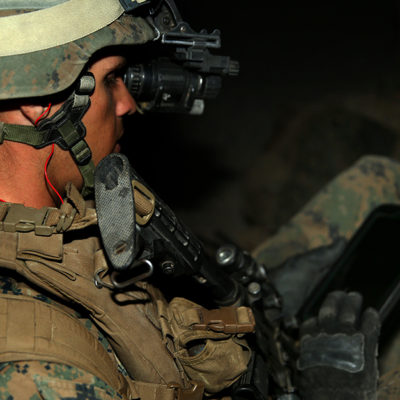 solider looks down at tablet during training exercise in Twentynine Palms, CA
