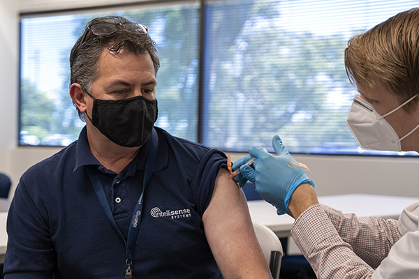 Intellisense Systems employee receiving vaccine shot